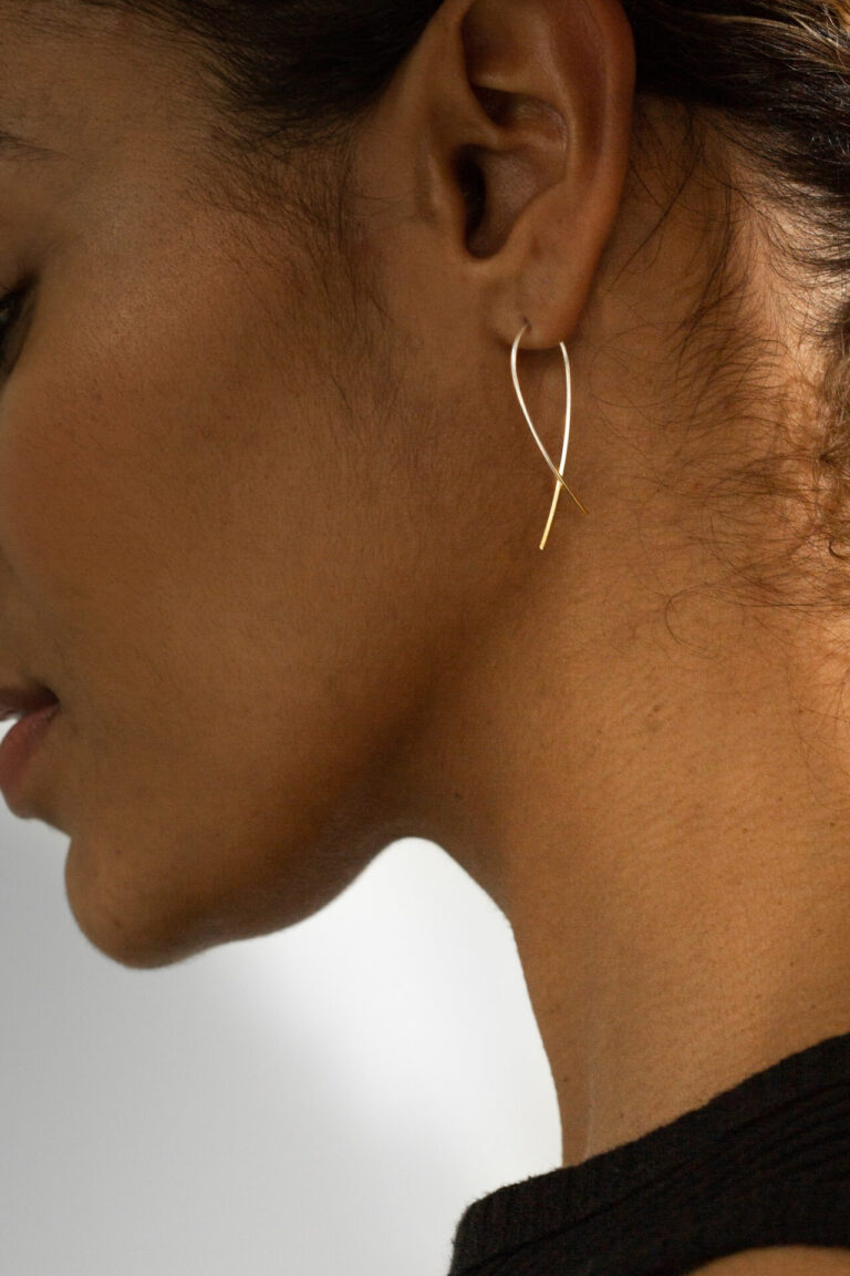Close up of the Gold Dipped Silver Crossover Earring worn in ear