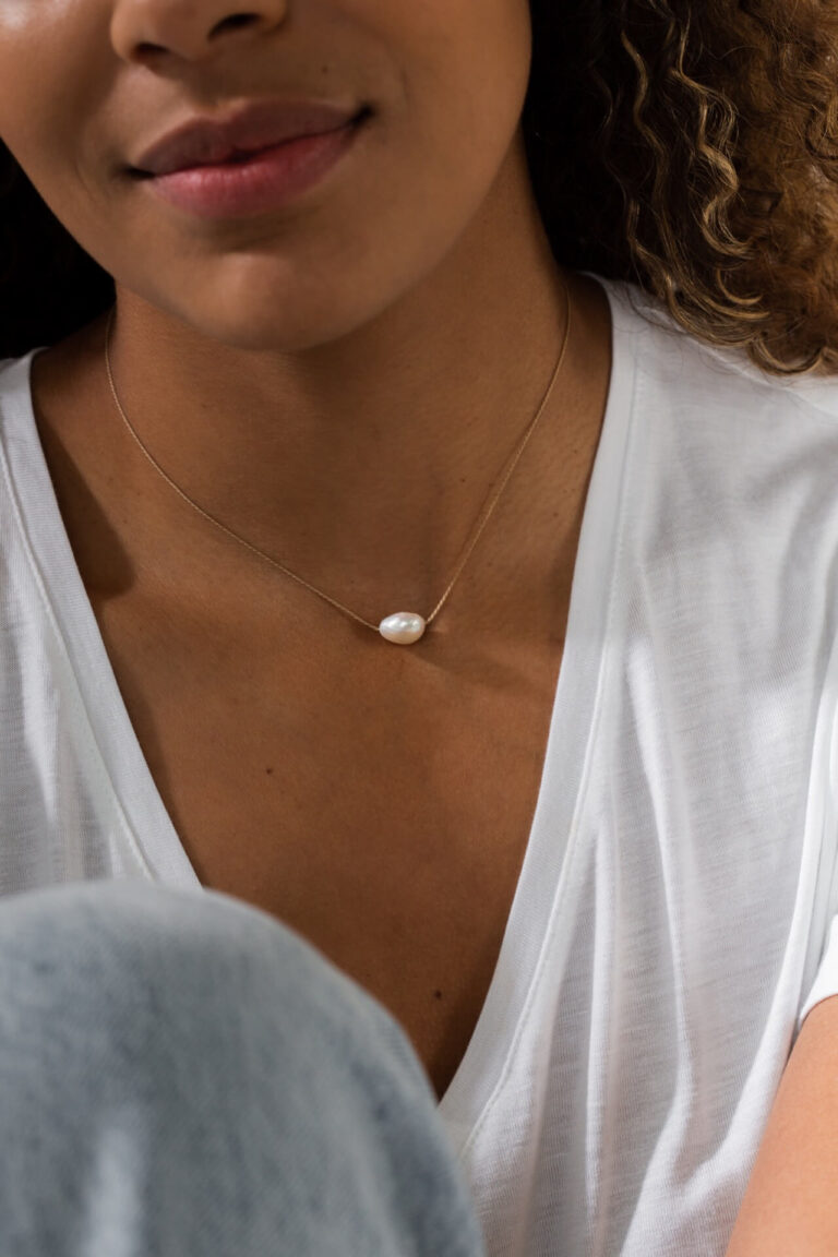 Pearl Gold Cord Necklace worn by model in white t-shirt