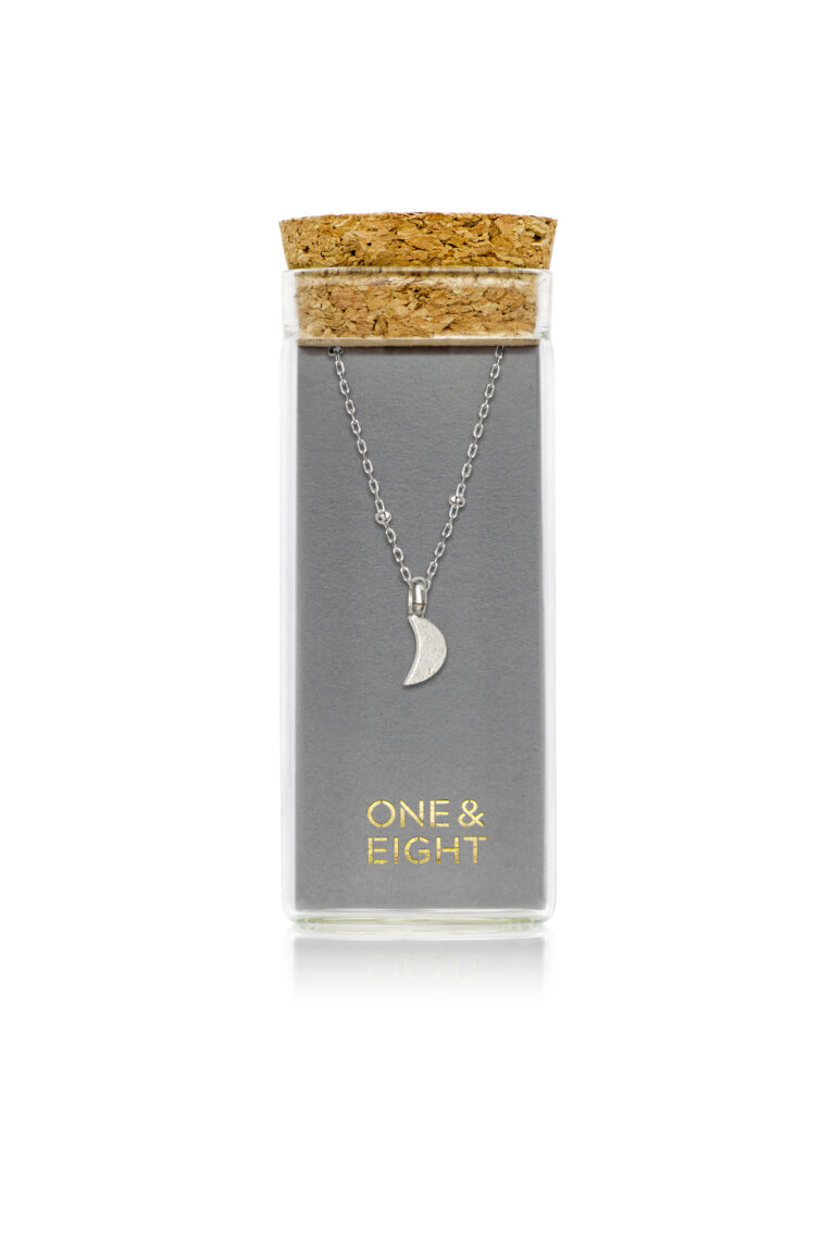 Silver Luna Moon Necklace on grey One & Eight card, in a glass bottle with cork lid