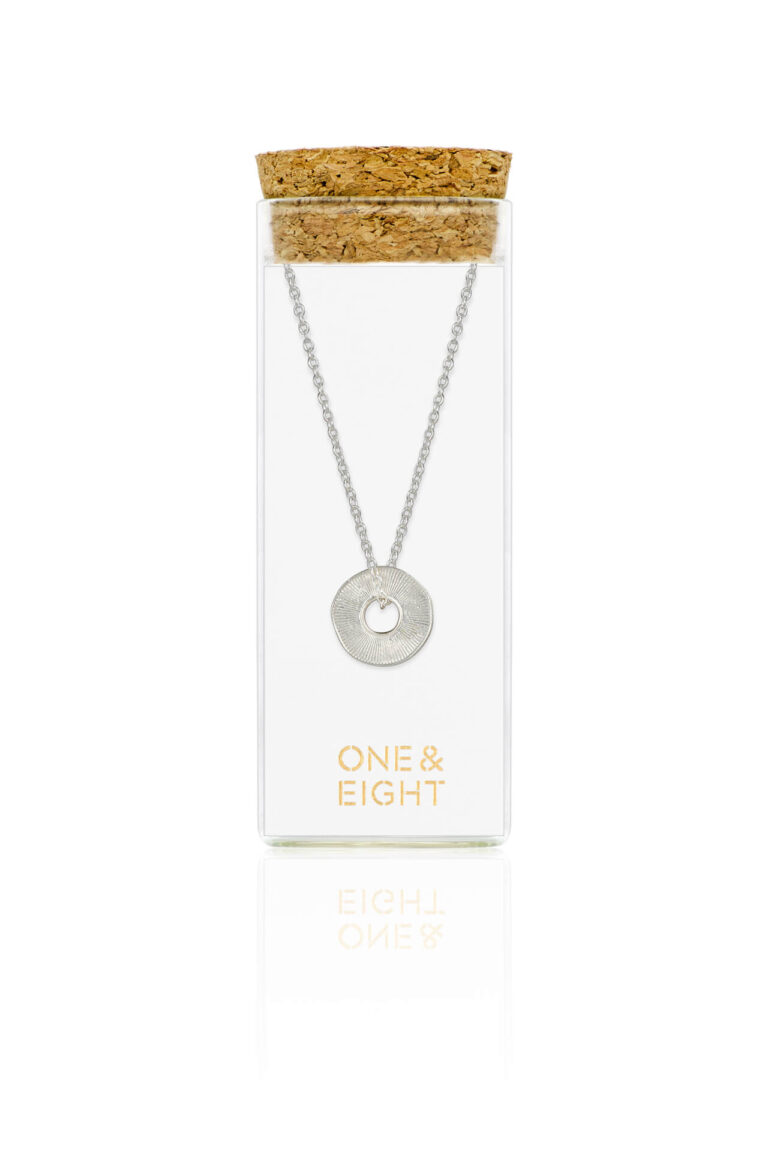 Silver Disc Sorrel Necklace in glass bottle with cork lid