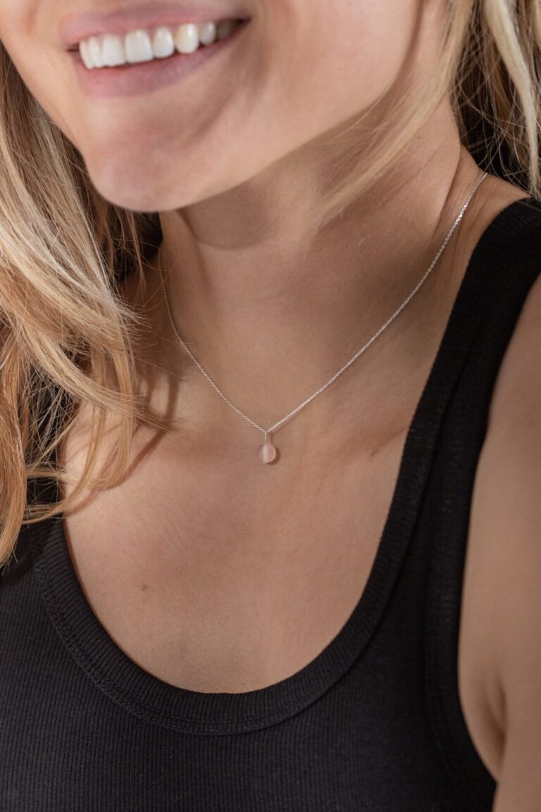 Close up of model with blonde hair wearing Periwinkle Pink Sea Glass Necklace and black tank top