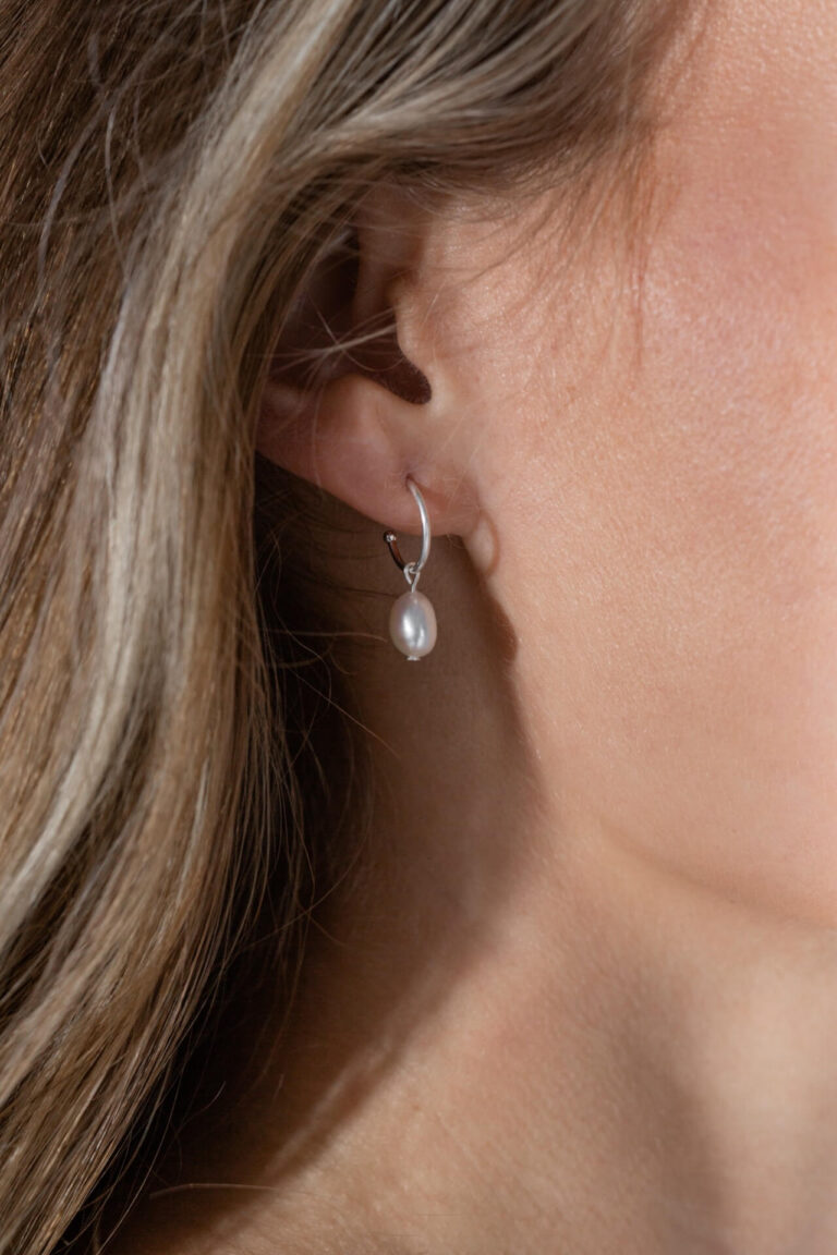 Close up of model wearing the Silver Pearl Drop Earrings