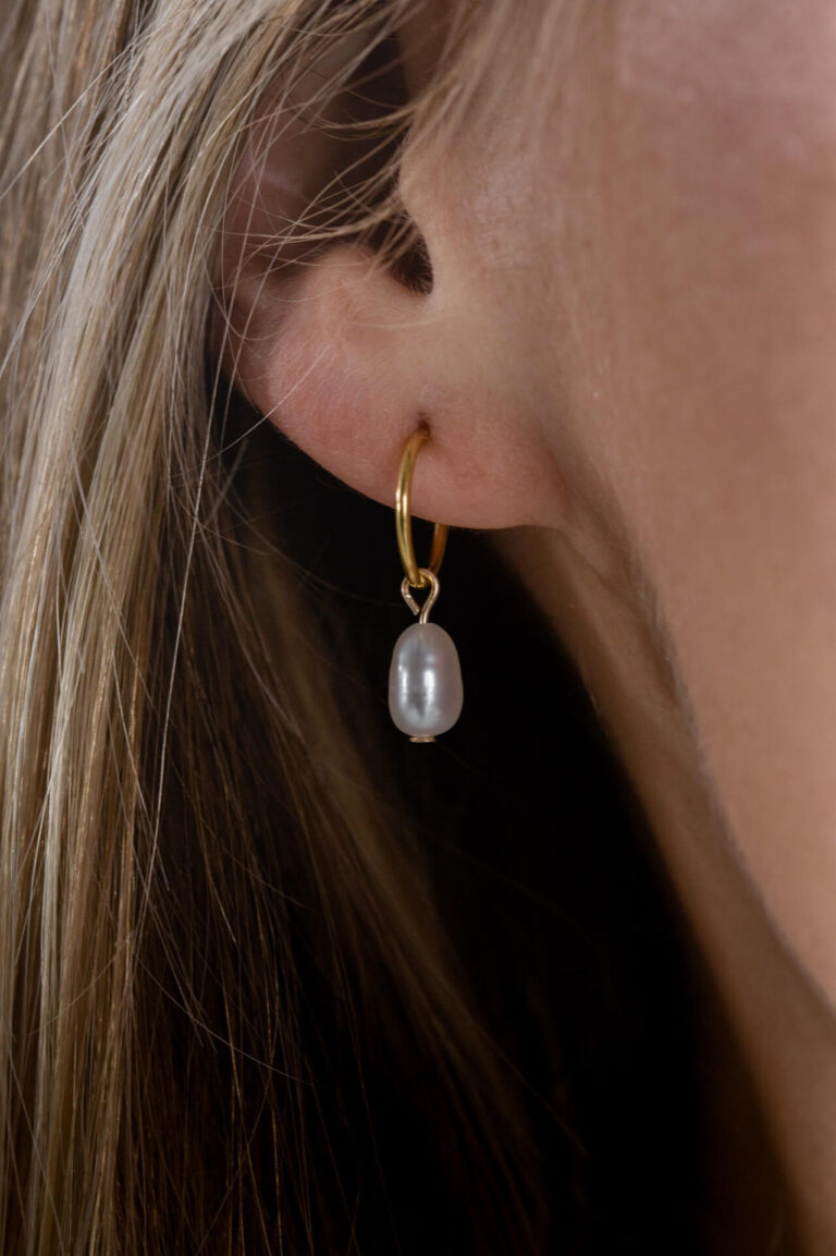 Close up of model wearing the Gold Pearl Drop Earrings