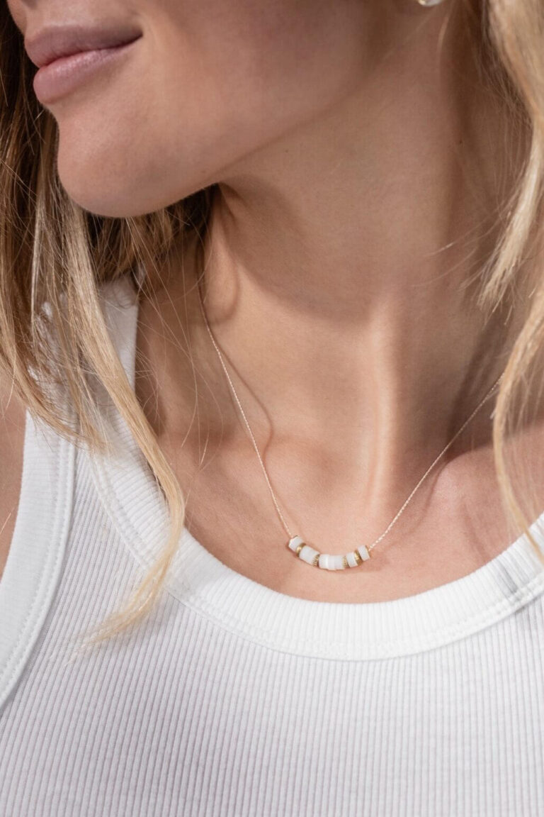 Close up of model with blonde hair wearing Protective Vibes Mother of Pearl Necklace