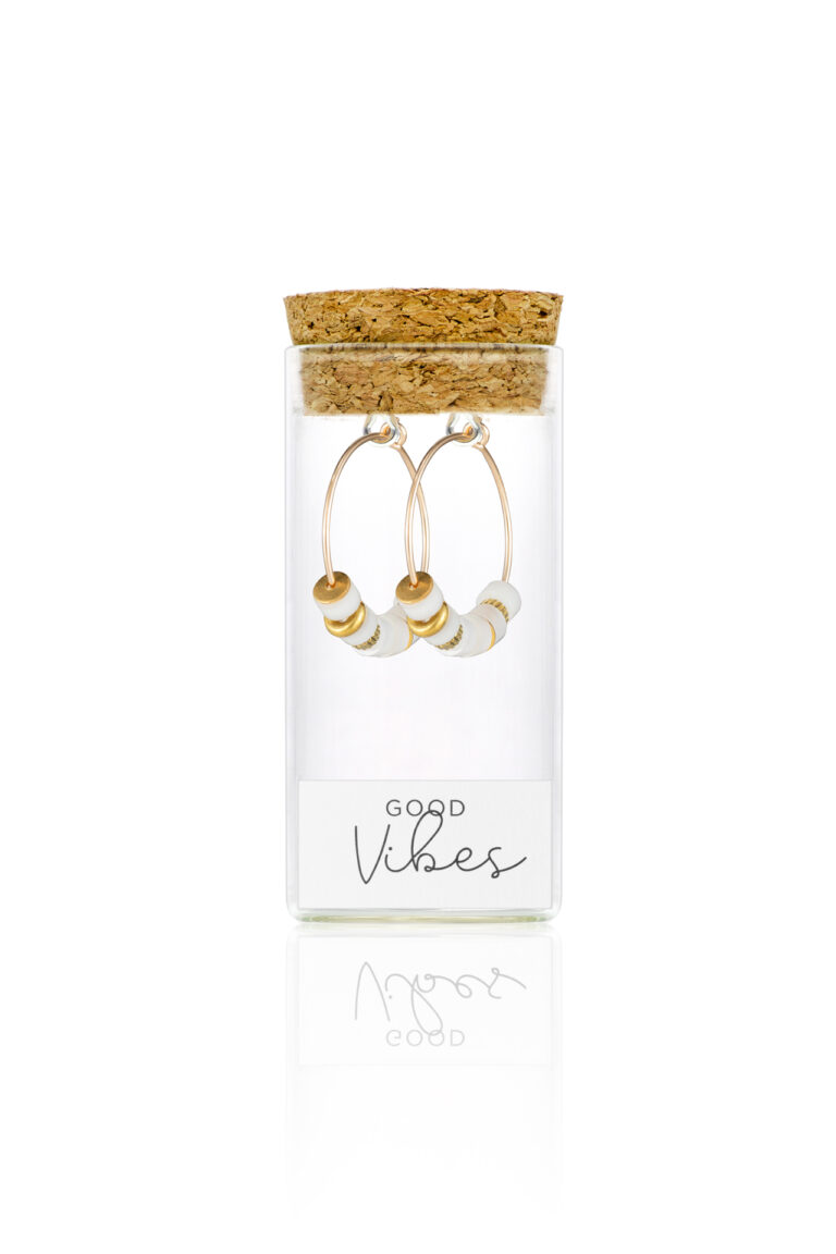 Protective Vibes Mother of Pearl Earrings in a glass bottle with cork lid