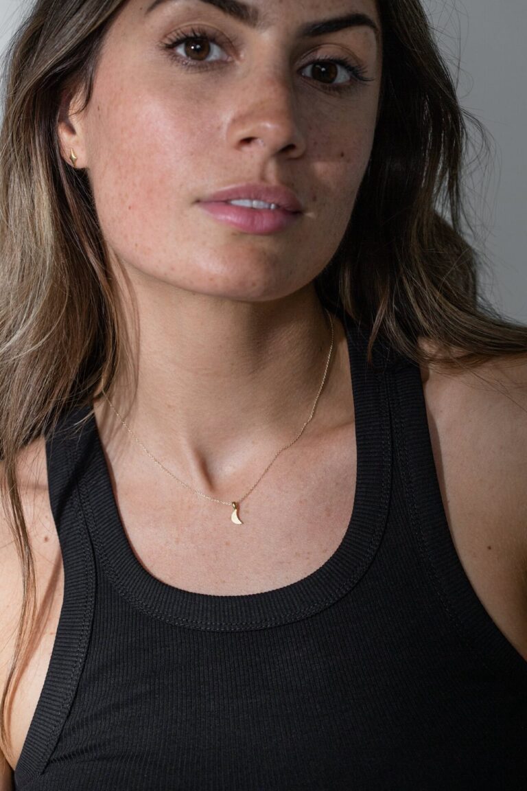 Model wears Gold Luna Moon Necklace and black tank top