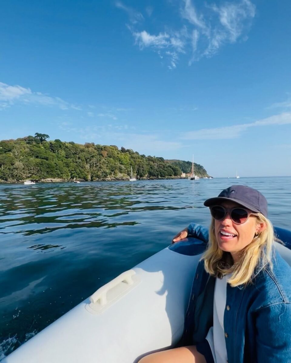 Outside in a boat on the sea.