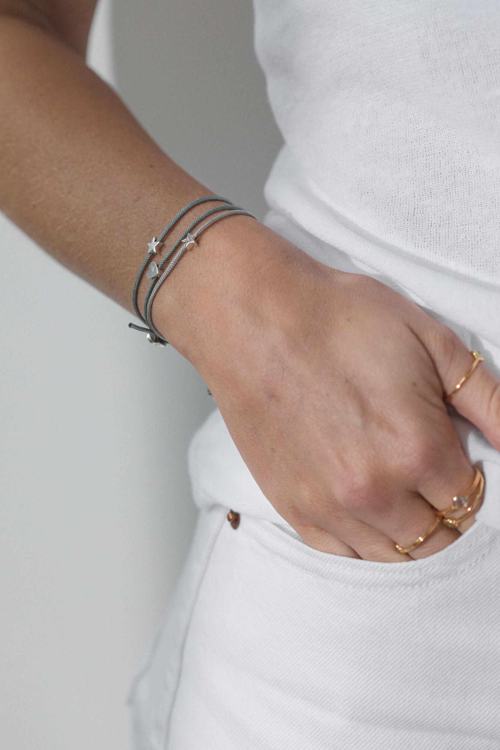 One-and-Eight-GV Silver Star on Sage Cord Bracelet Silver Star on Grey Cord Bracelet Silver Heart on Sage Cord Bracelet Model Web Size 4-AW25